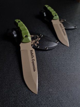 "Tiger Hunters: Buy a Tourist Knife for a Great Adventure" (tan polymer, green handle, black scabbard)
