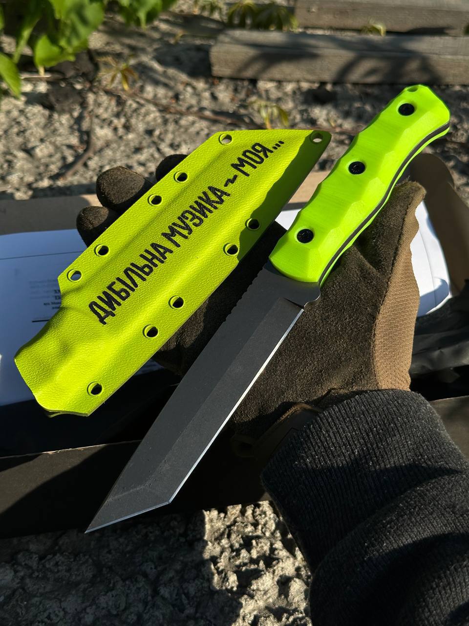 Lime green Tanto knife with Dumb music quote on the sheath